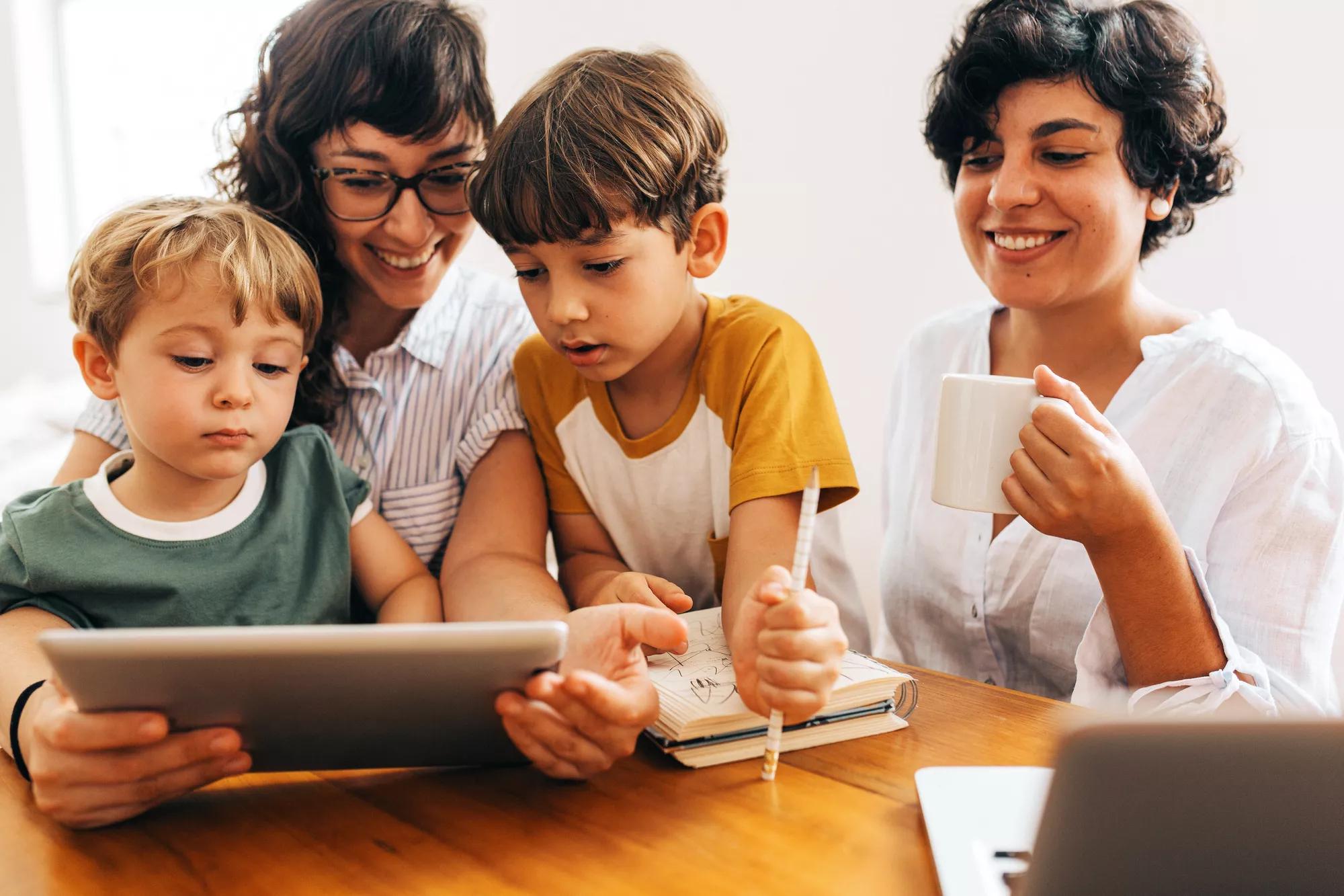 A family sitting together looking at a tablet.
